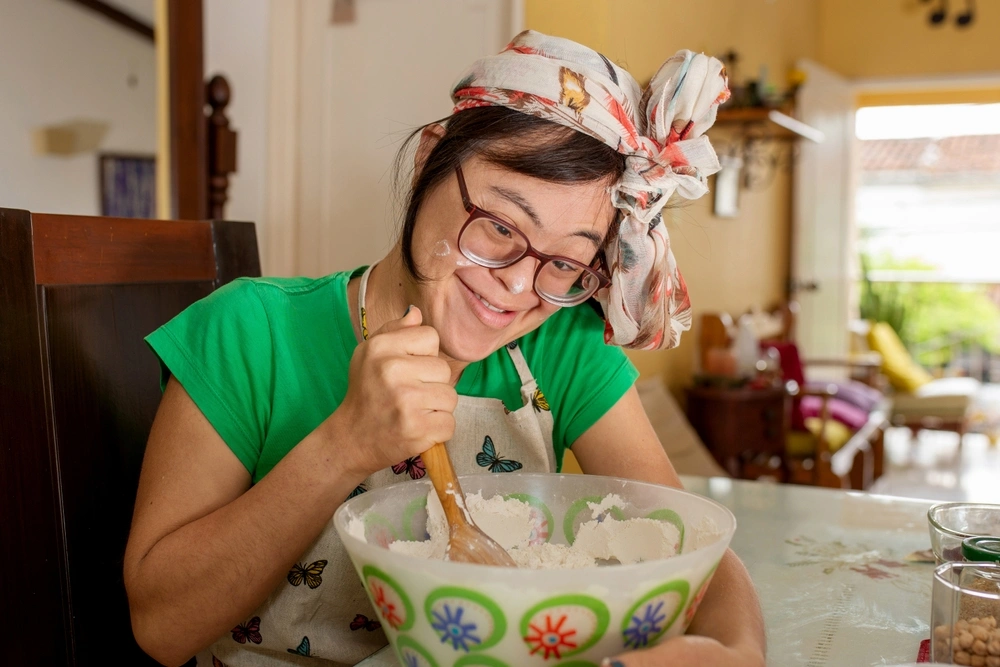 Disabled girl baking in kitchen